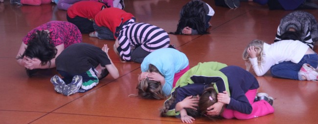 Students and teachers practising Drop Cover Hold.