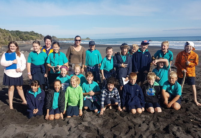 TRC Environment Education - Dr Emily Roberts with students at the beach